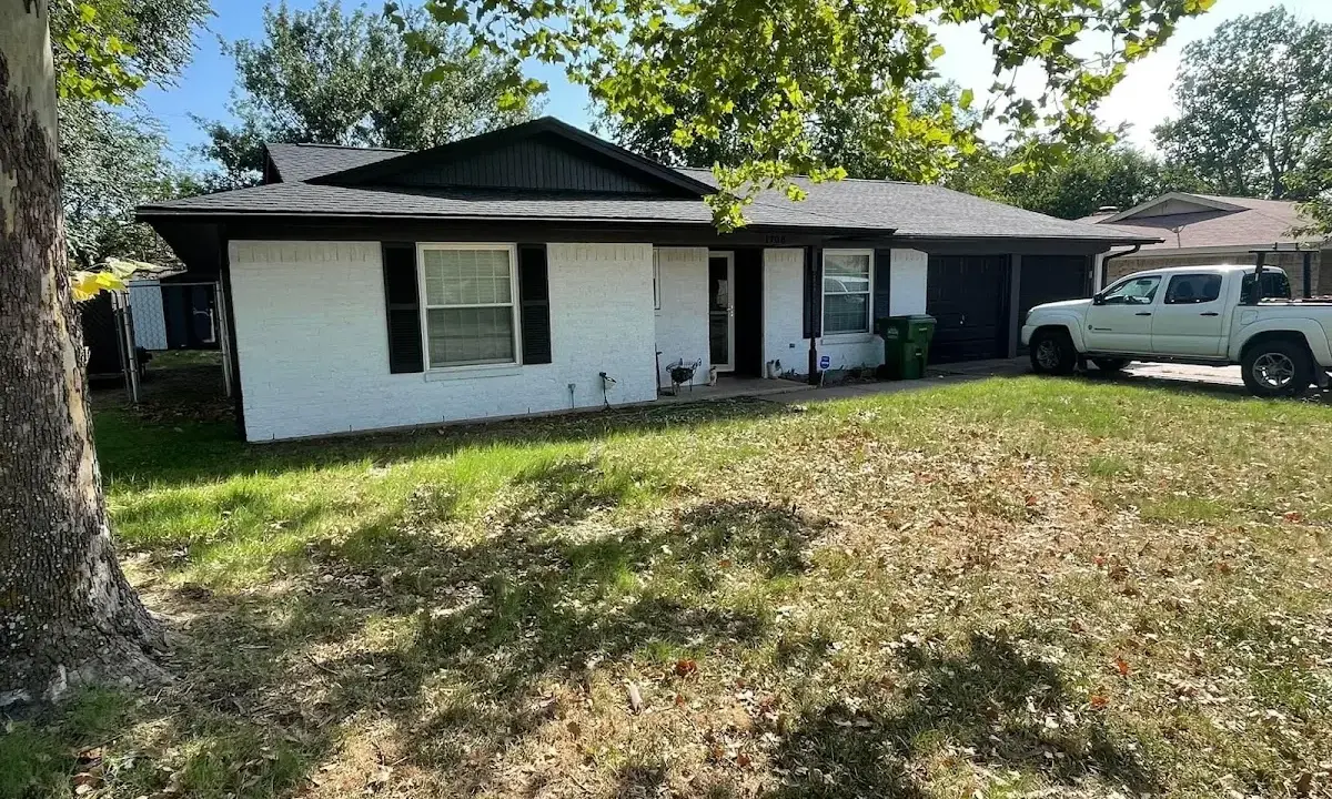 Professional roofing crew working on a residential roof in De Witt